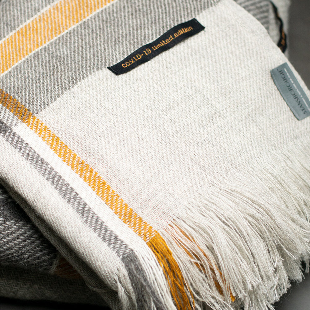 Stansborough New Zealand Wool Throw Rug Grey Gold Stripe Folded Up Close